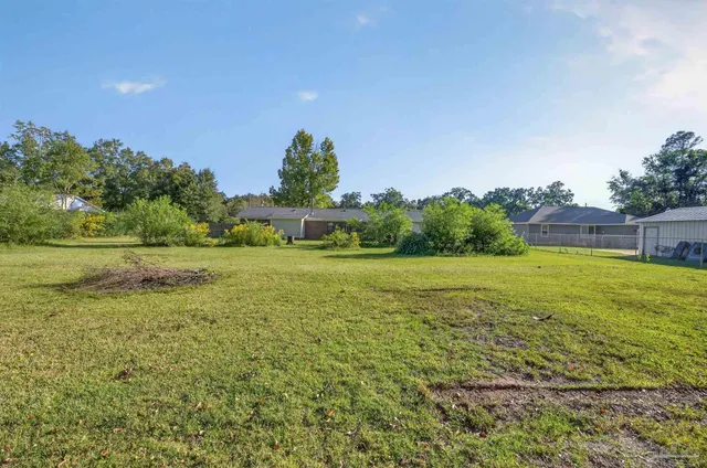 a front view of a house with yard and green space
