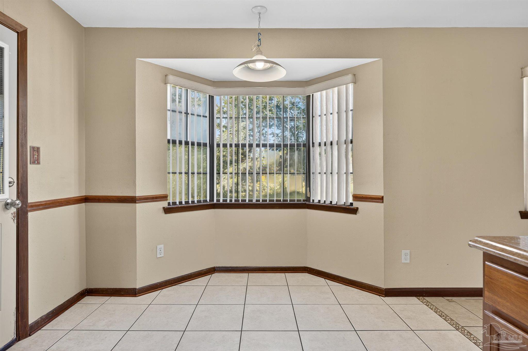 1120 Muscogee Road Cantonment, FL 32533 - Photo 6 of 38 a view of an empty room with windows