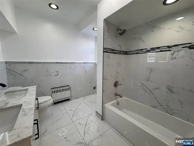a bathroom with a bathtub and a shower