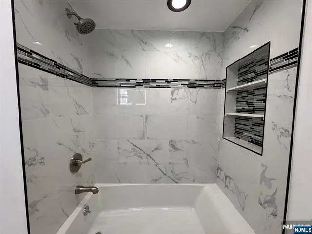 a bathroom with a shower and a bathtub