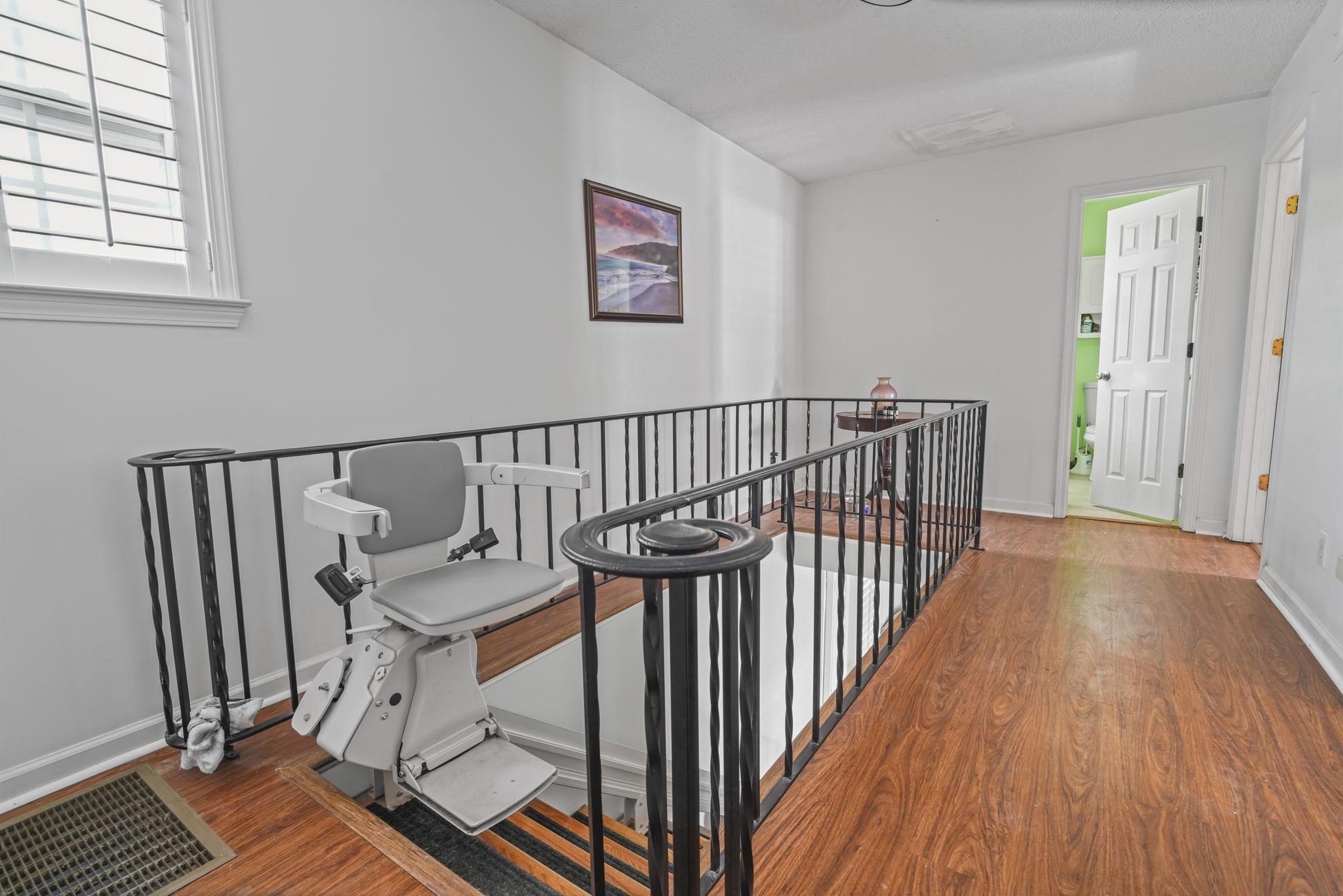 408 Rosemary Street Georgetown, SC 29440 - Photo 14 of 34 Hall with wood finished floors and an upstairs landing