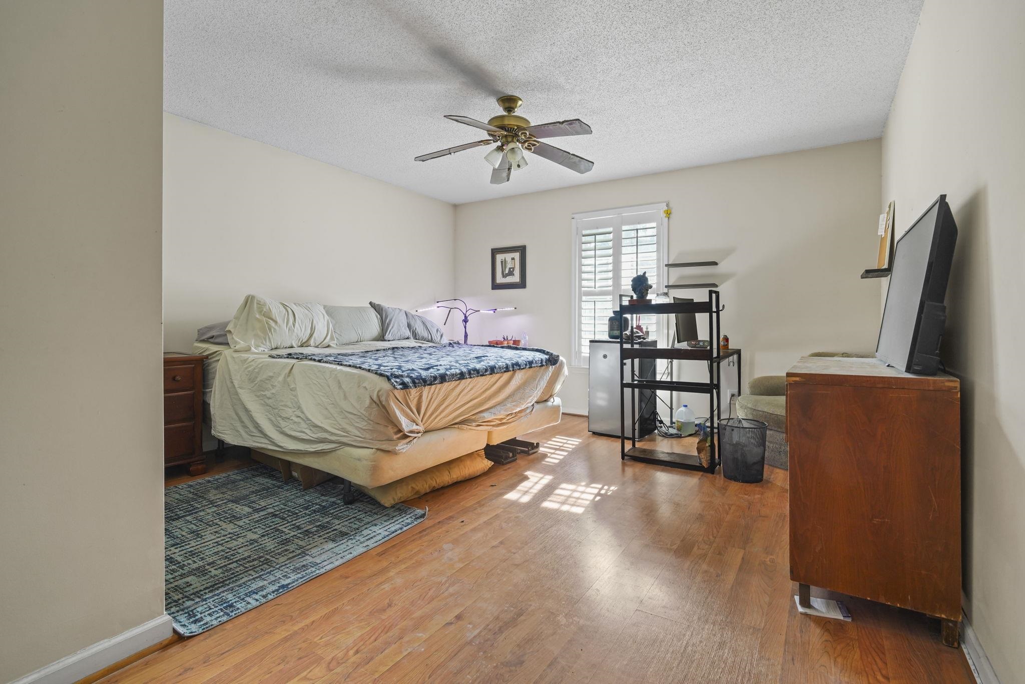 408 Rosemary Street Georgetown, SC 29440 - Photo 16 of 34 Bedroom featuring hardwood / wood-style flooring, a textured ceiling, and ceiling fan