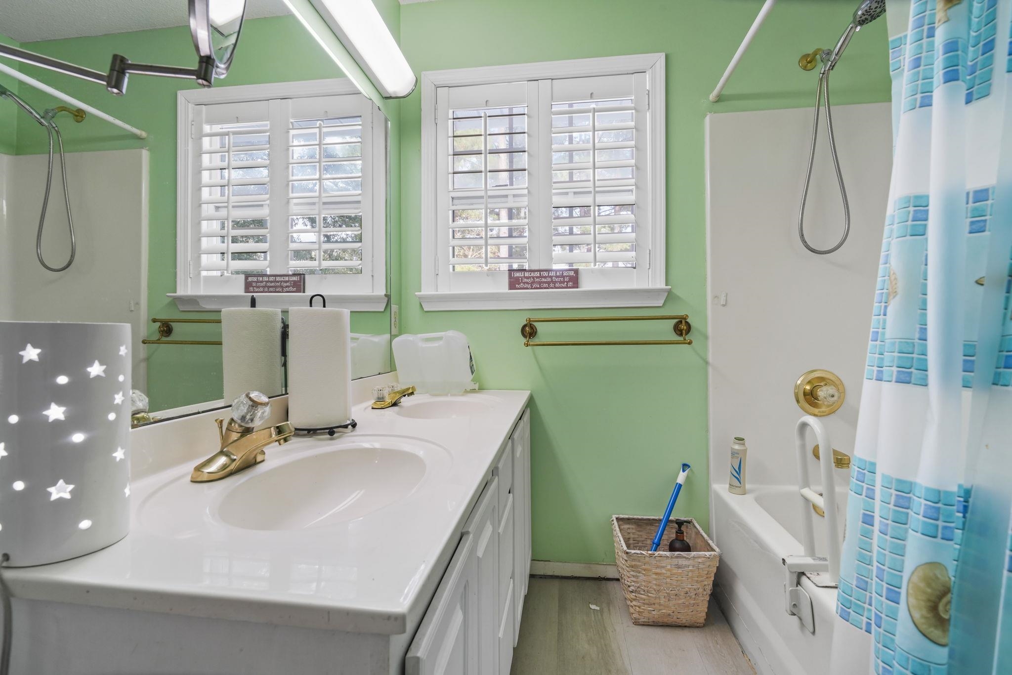 408 Rosemary Street Georgetown, SC 29440 - Photo 18 of 34 Full bath featuring double vanity, shower / bath combo with shower curtain, and light wood-style floors