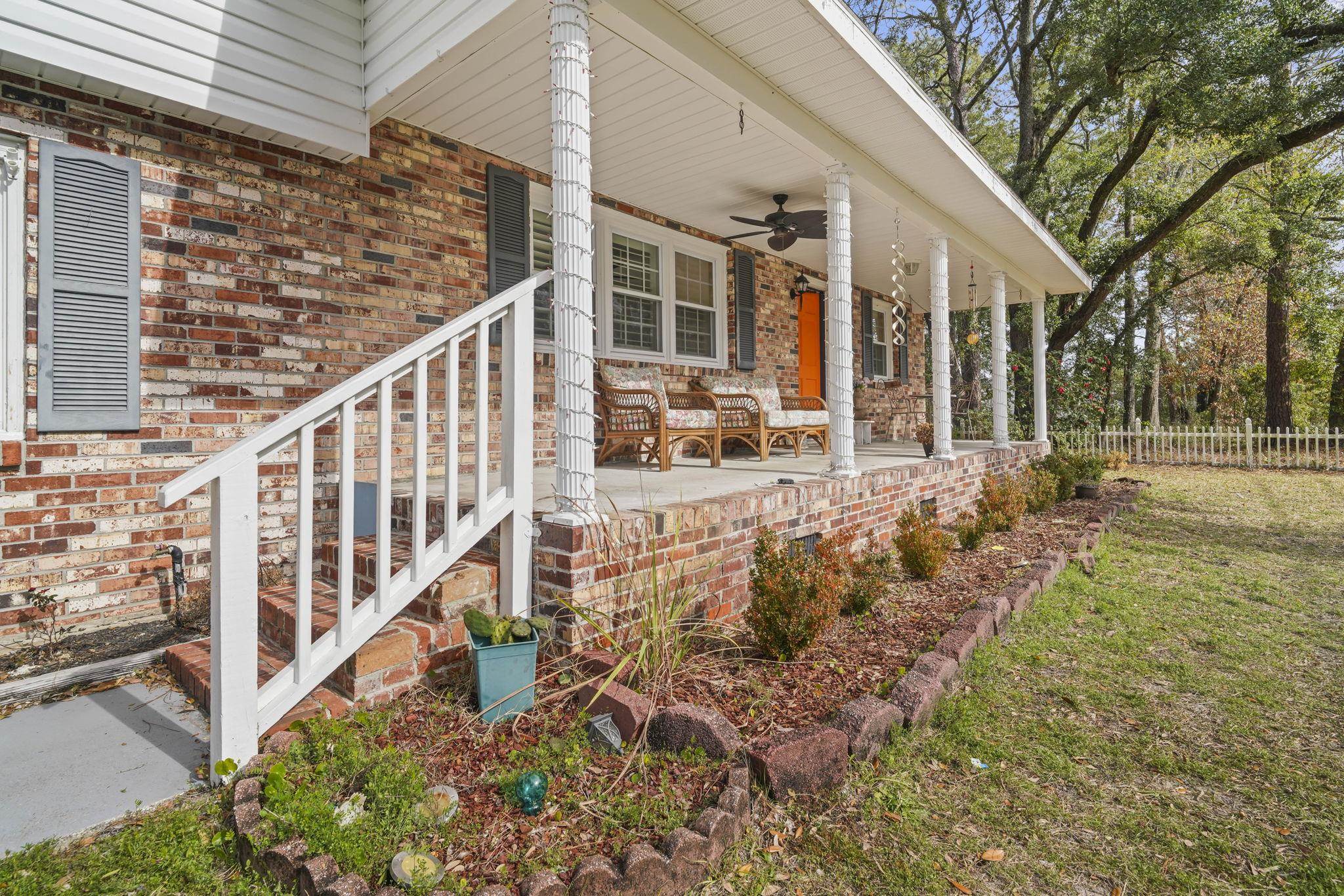 408 Rosemary Street Georgetown, SC 29440 - Photo 2 of 34 View of exterior entry featuring covered porch, a ceiling fan, and brick siding