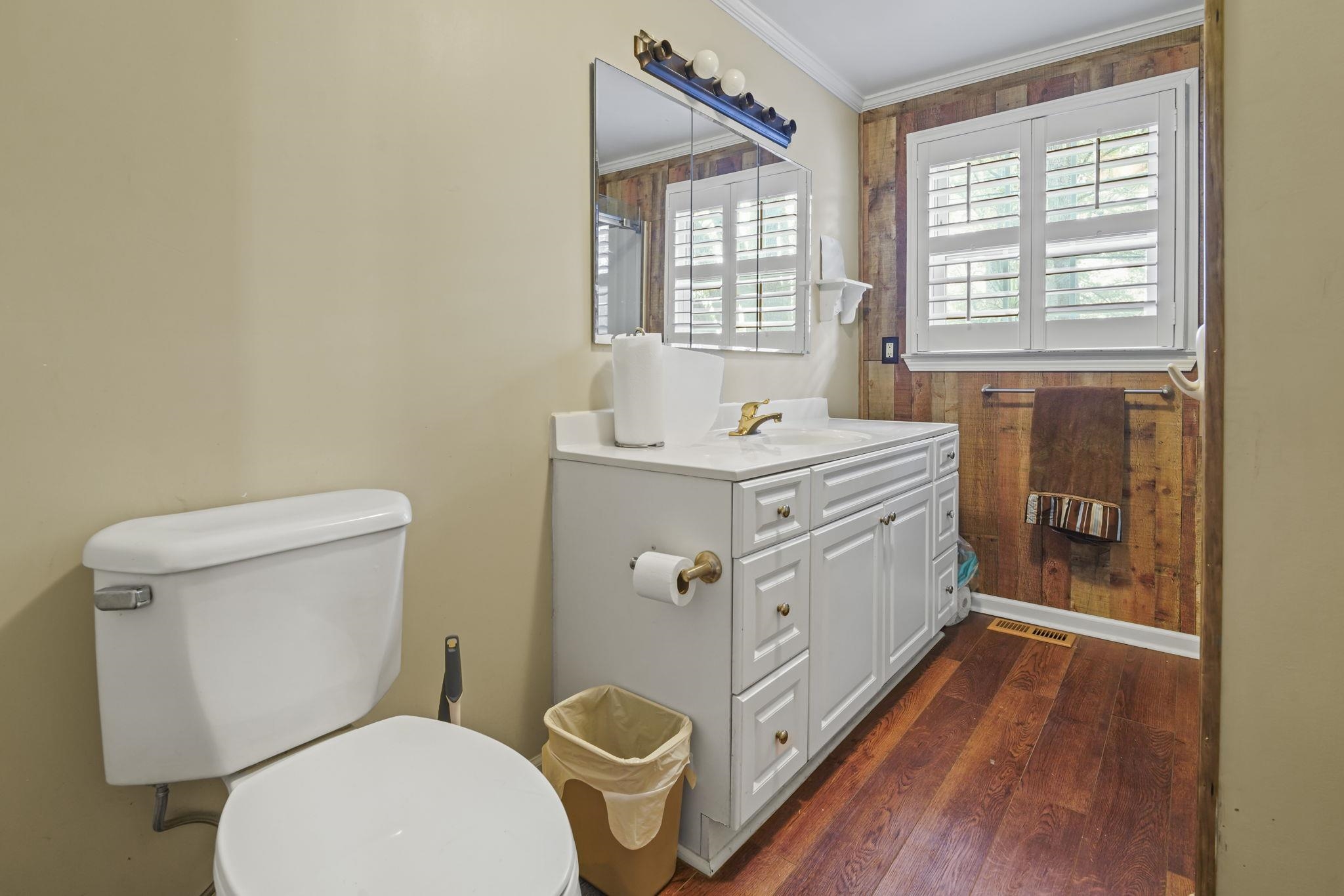 408 Rosemary Street Georgetown, SC 29440 - Photo 21 of 34 Bathroom featuring vanity, dark wood-style floors, and ornamental molding