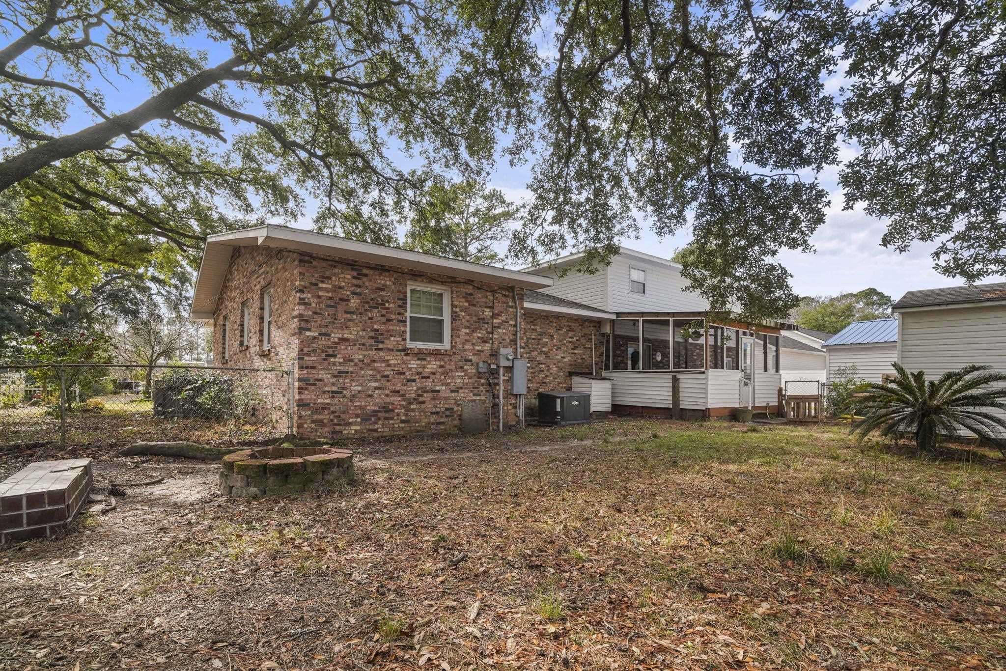 408 Rosemary Street Georgetown, SC 29440 - Photo 24 of 34 Rear view of property featuring a sunroom and brick siding