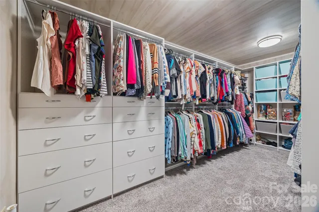 a view of walk in closet with clothes