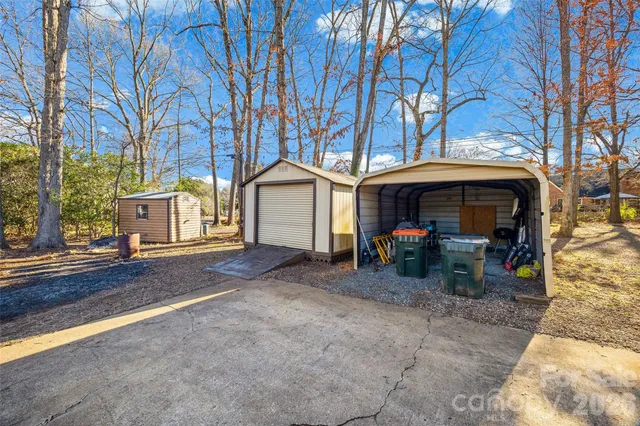a view of a house with brick walls and a car parked
