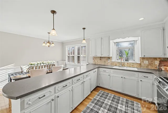 a kitchen with a sink stove and cabinets