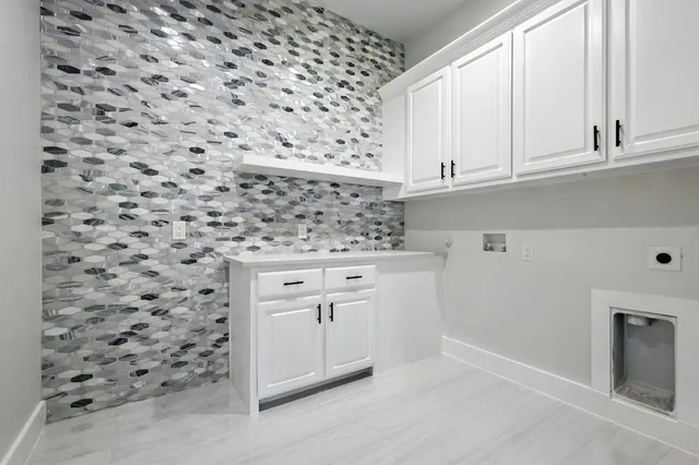 a dining room with furniture and a large window