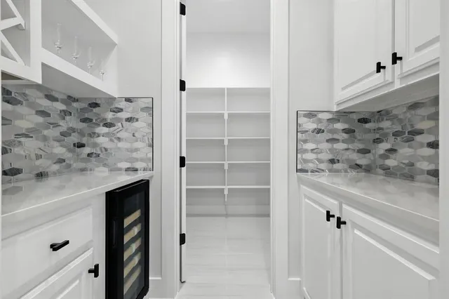 a kitchen with a dining table chairs and cabinets