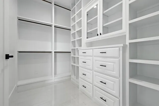 a spacious bathroom with a double vanity sink and a mirror
