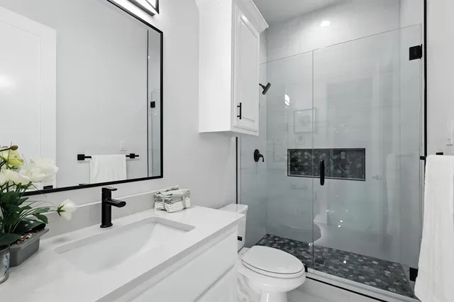a bathroom with a glass shower door