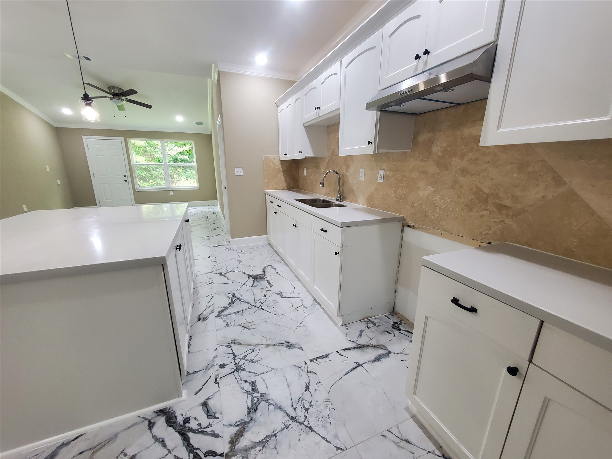 1306 North 9th Street Conroe, TX 77301 - Photo 27 of 47 a kitchen with a sink a refrigerator and window