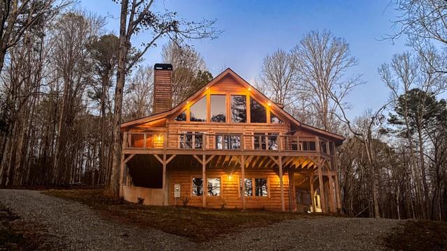 1725 Cherokee Gold Trail Ball Ground, GA 30107 - Photo 1 of 57 a front view of a house with a yard