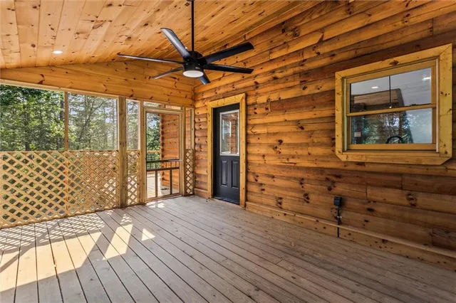 a bedroom with a bed a window and a chandelier