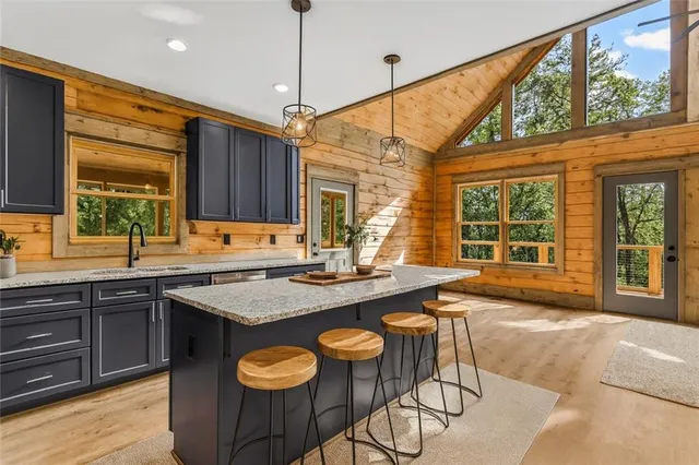 a kitchen with a stove a sink and a wooden cabinets