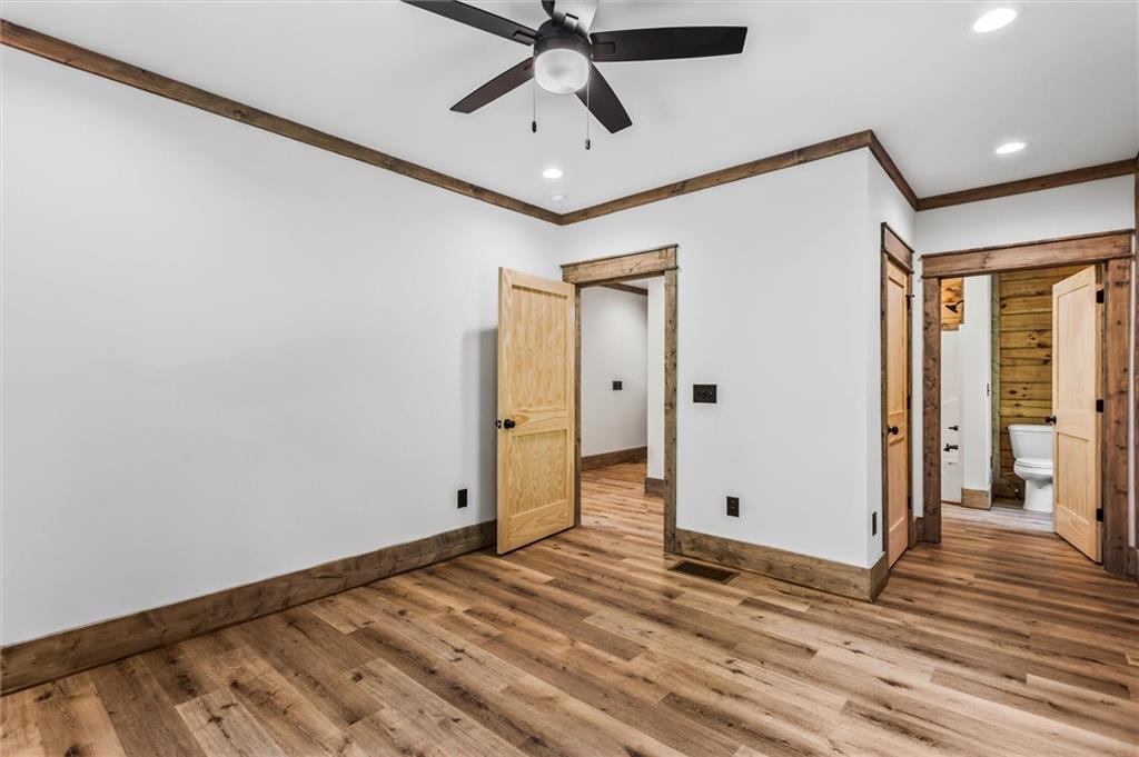 1725 Cherokee Gold Trail Ball Ground, GA 30107 - Photo 21 of 57 a view of a livingroom with wooden floor and white walls
