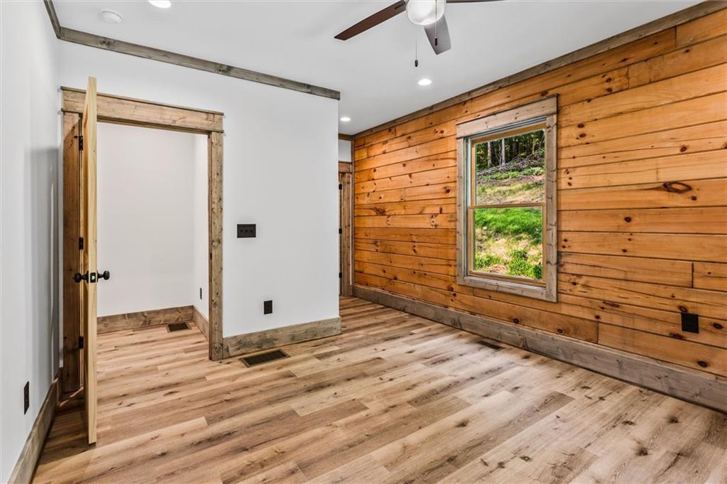 1725 Cherokee Gold Trail Ball Ground, GA 30107 - Photo 22 of 57 a view of an empty room with a window and wooden floor