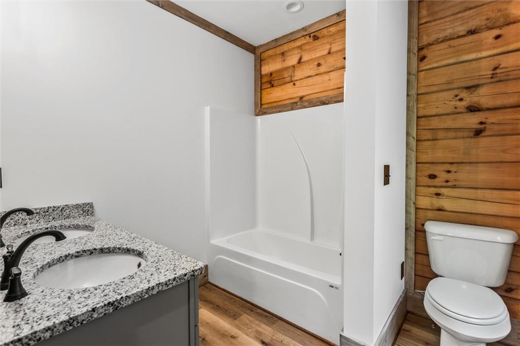 1725 Cherokee Gold Trail Ball Ground, GA 30107 - Photo 23 of 57 a bathroom with a granite countertop sink and a toilet