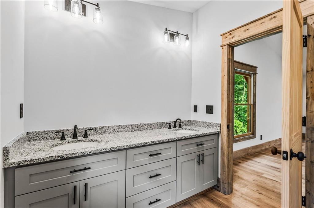 1725 Cherokee Gold Trail Ball Ground, GA 30107 - Photo 31 of 57 a bathroom with a granite countertop sink and a mirror