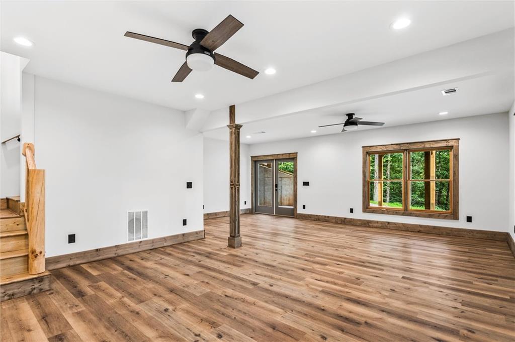1725 Cherokee Gold Trail Ball Ground, GA 30107 - Photo 35 of 57 a view of an empty room with a window and wooden floor