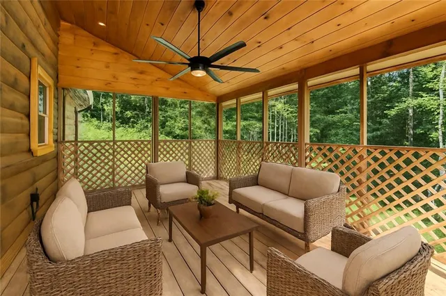 a balcony with furniture and a garden view