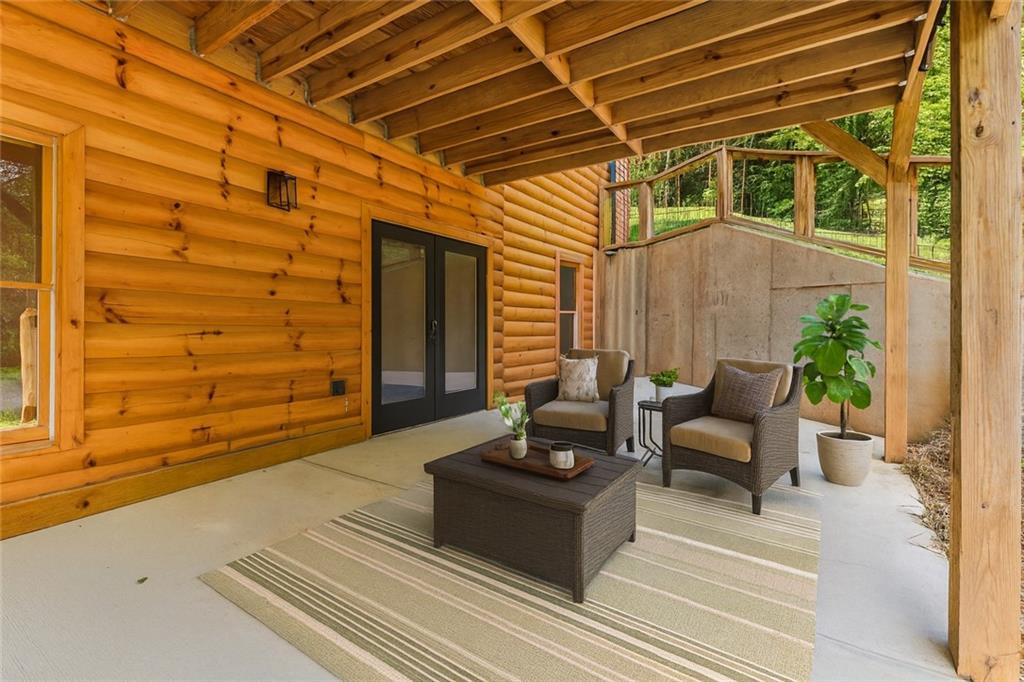 1725 Cherokee Gold Trail Ball Ground, GA 30107 - Photo 42 of 57 a outdoor space with the couches and a potted plant