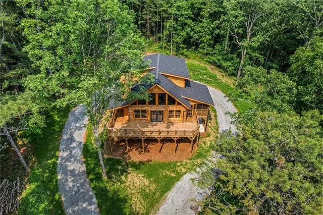 a view of a house with a small yard and wooden fence