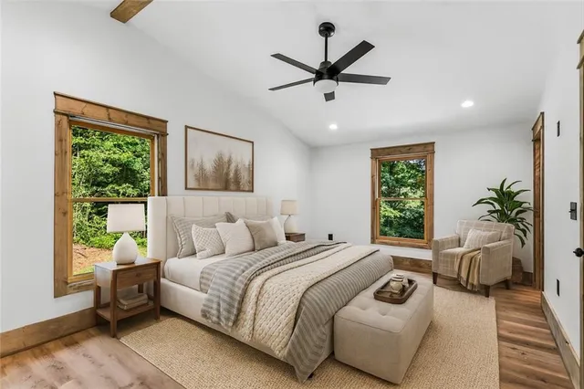 a bedroom with a bed a couch and a window