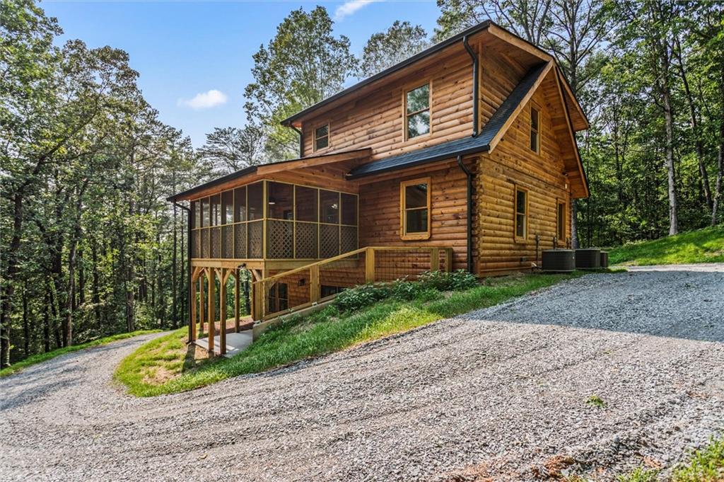 1725 Cherokee Gold Trail Ball Ground, GA 30107 - Photo 56 of 57 a view of a house with a small yard and wooden fence