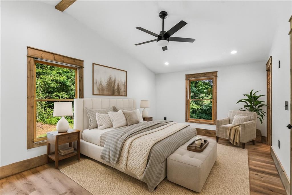 1725 Cherokee Gold Trail Ball Ground, GA 30107 - Photo 6 of 57 a bedroom with a bed a couch and a window
