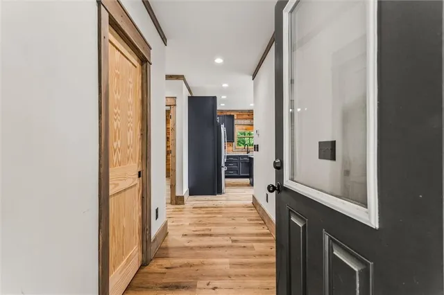 a view of a hallway with wooden floor and staircase