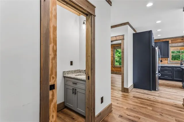 a view of kitchen with stainless steel appliances granite countertop cabinets and chandelier