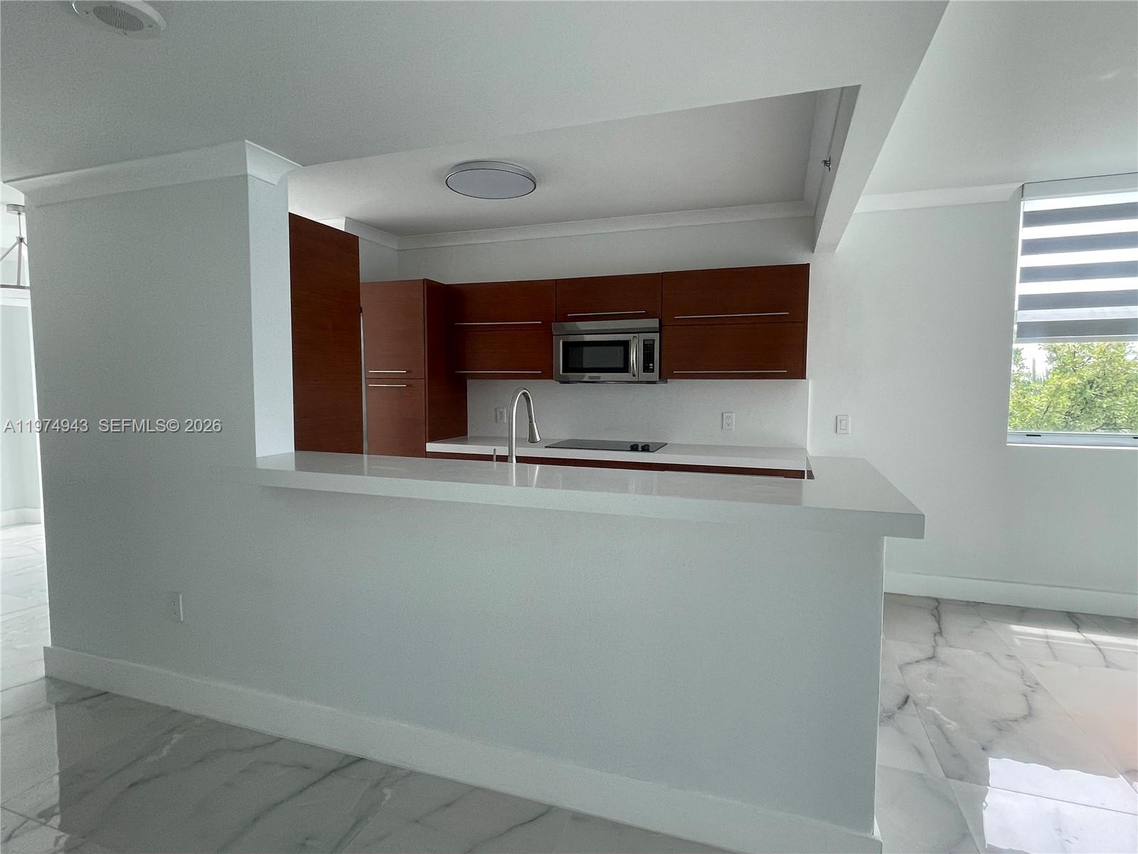 2681 North Flamingo Road, Unit 401S Sunrise, FL 33323 - Photo 13 of 18 a kitchen with stainless steel appliances a refrigerator and a stove top oven