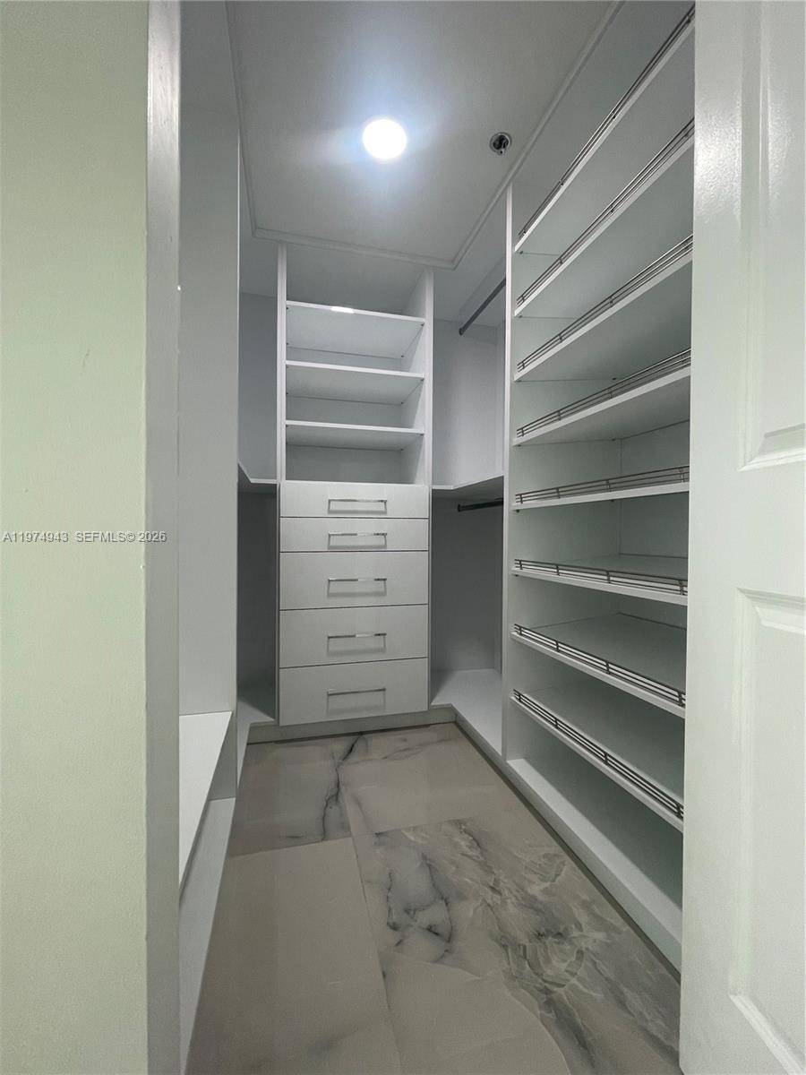 2681 North Flamingo Road, Unit 401S Sunrise, FL 33323 - Photo 14 of 18 a view of walk in closet with empty racks
