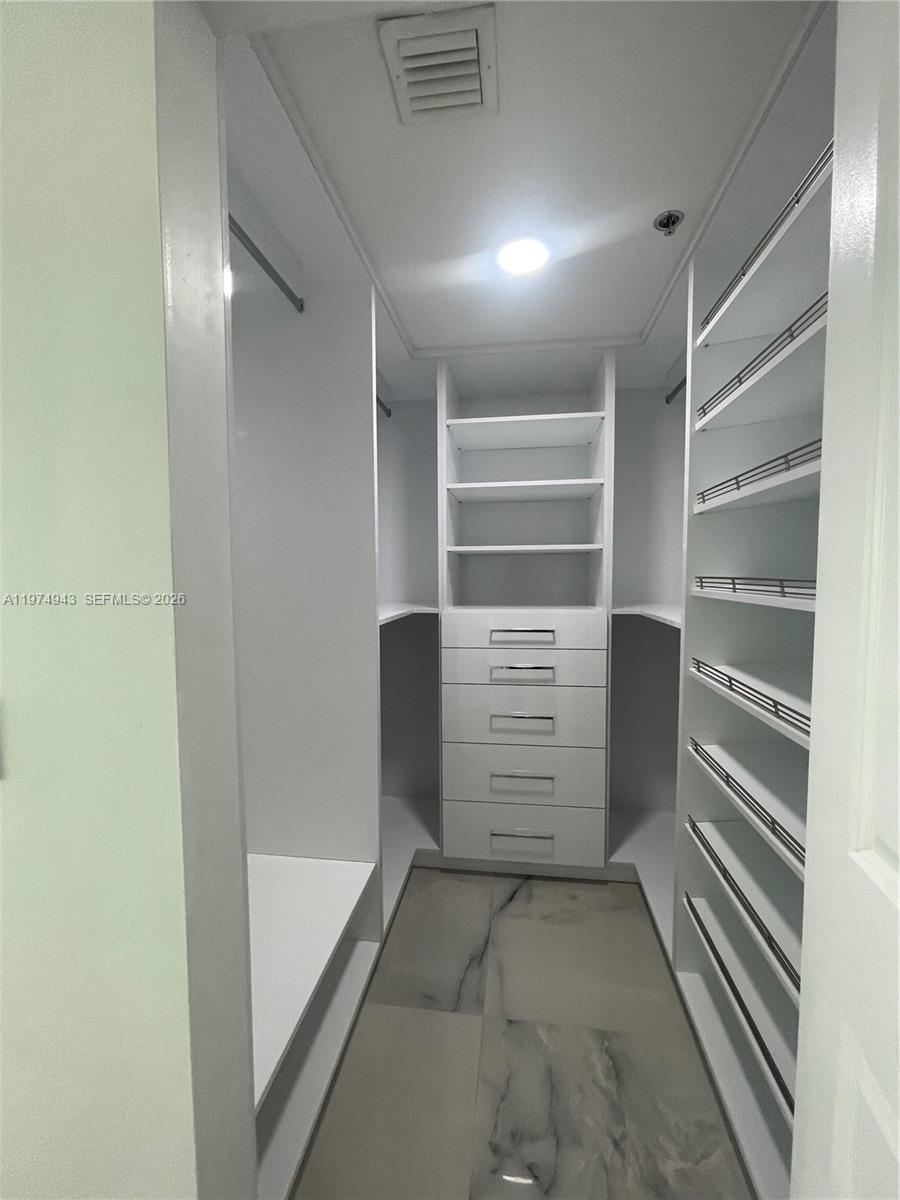 2681 North Flamingo Road, Unit 401S Sunrise, FL 33323 - Photo 15 of 18 a view of walk in closet with empty racks