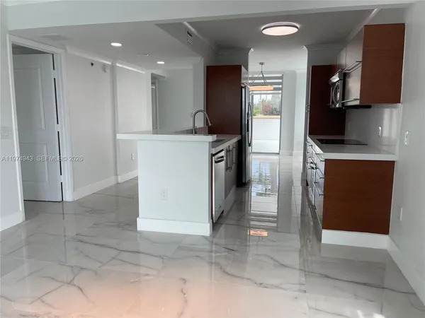 a view of a livingroom with wooden floor and chandelier