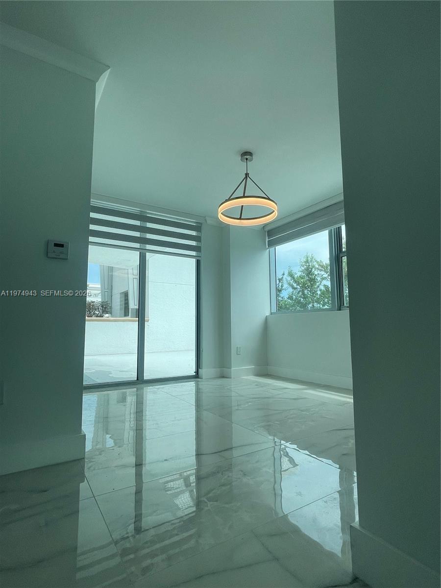 2681 North Flamingo Road, Unit 401S Sunrise, FL 33323 - Photo 17 of 18 a view of a livingroom with wooden floor and chandelier
