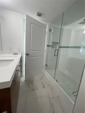 a bathroom with a sink and a shower