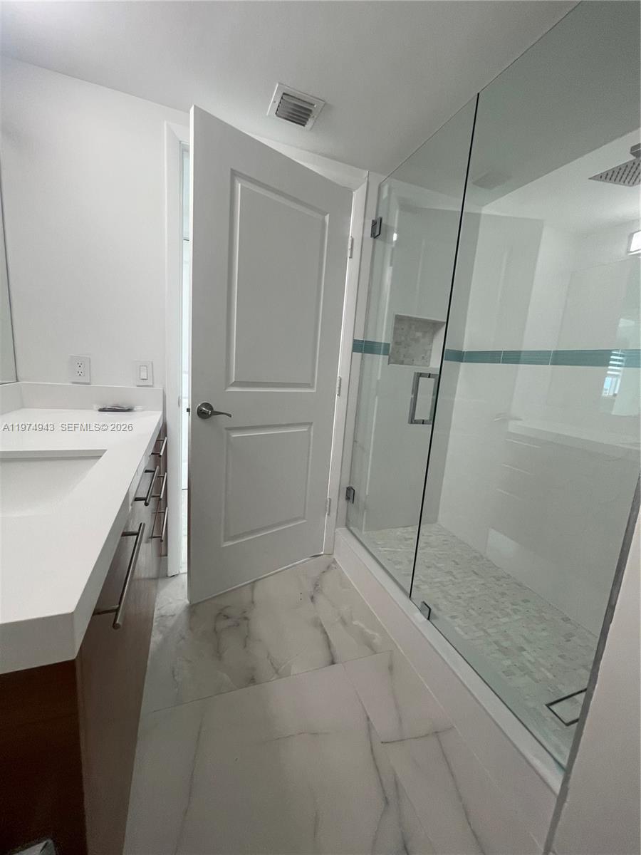 2681 North Flamingo Road, Unit 401S Sunrise, FL 33323 - Photo 7 of 18 a bathroom with a sink and a shower
