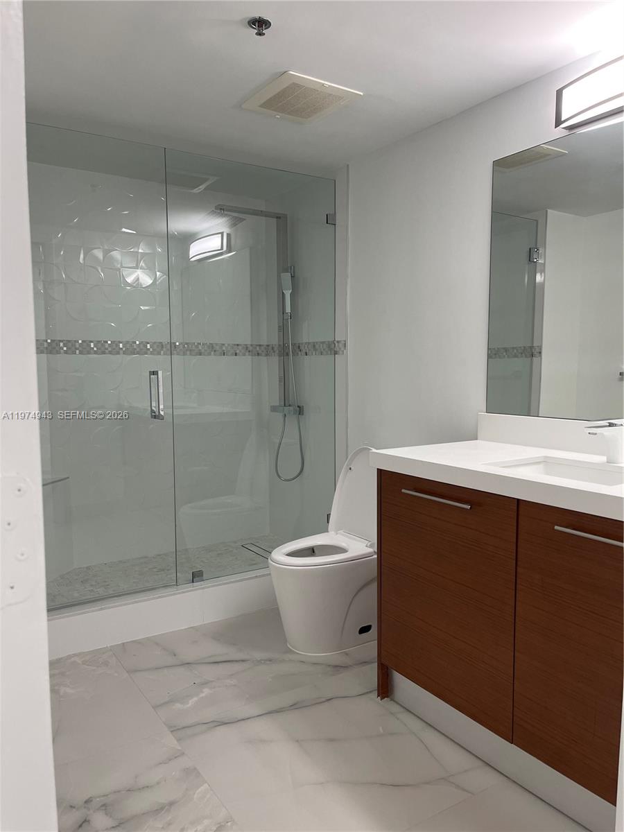 2681 North Flamingo Road, Unit 401S Sunrise, FL 33323 - Photo 9 of 18 a bathroom with a sink a toilet and shower