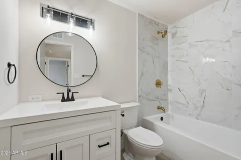 a bathroom with a sink a toilet and a mirror