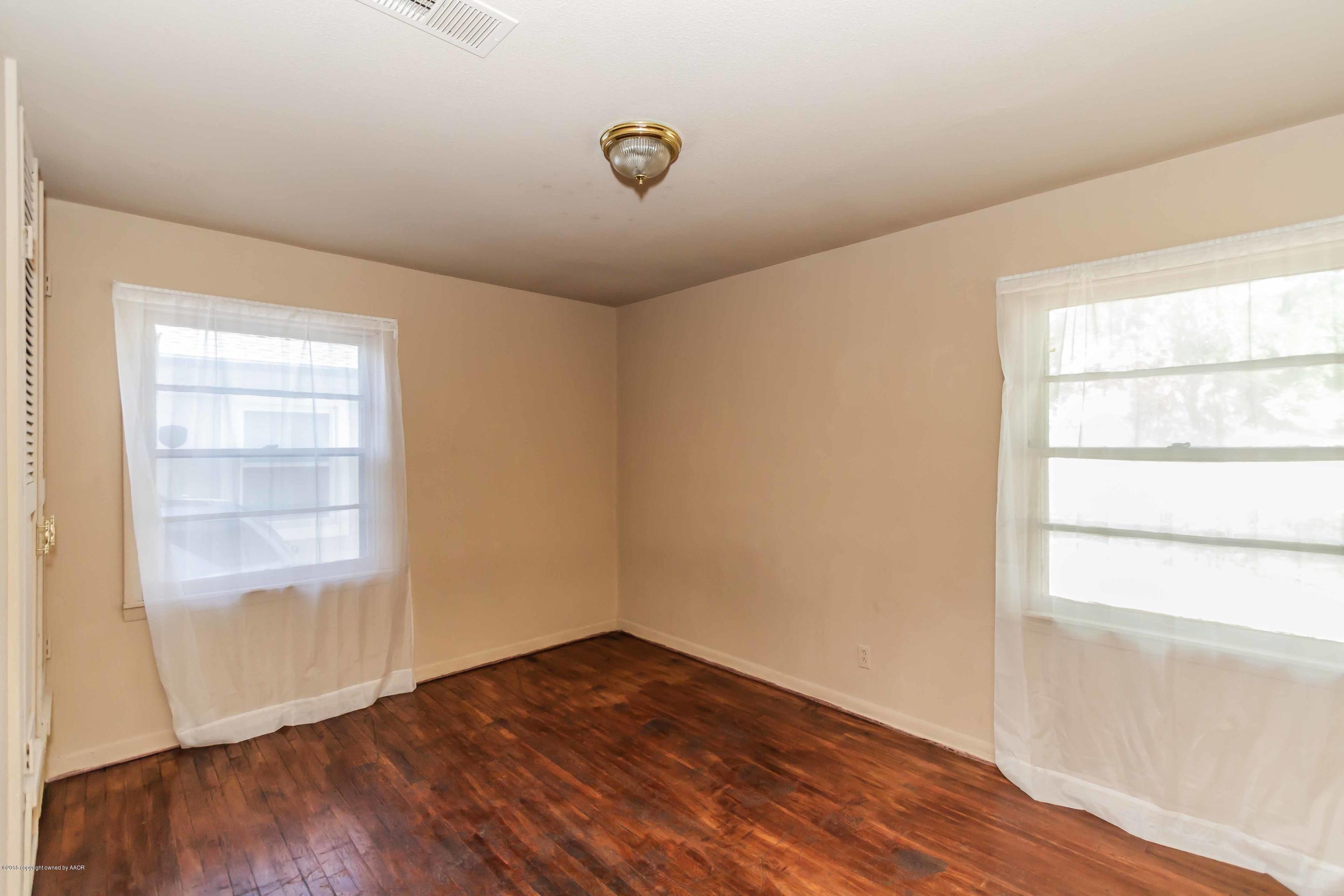 4307 Gables Street Amarillo, TX 79110 - Photo 15 of 32 an empty room with wooden floor and windows