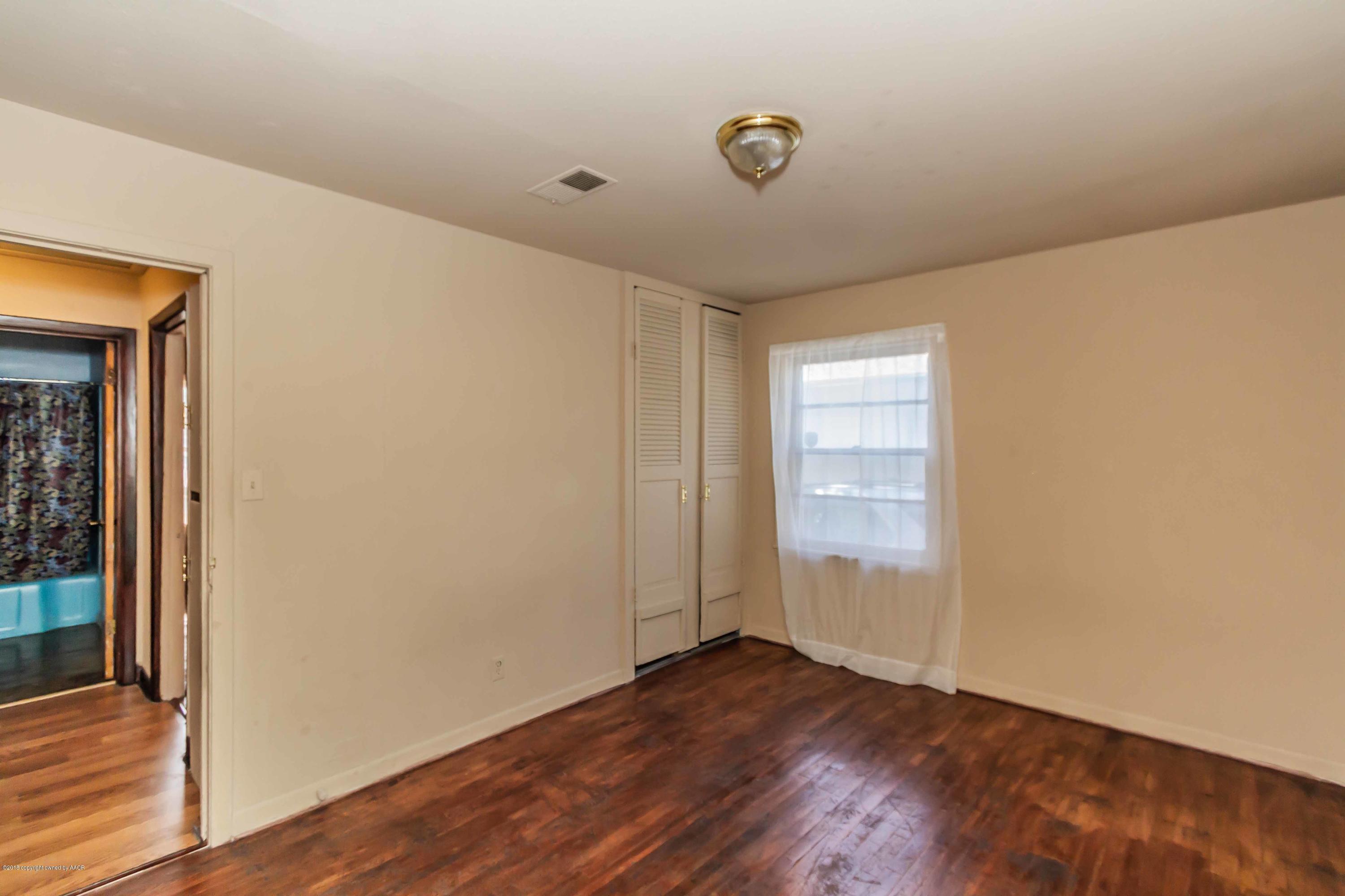 4307 Gables Street Amarillo, TX 79110 - Photo 16 of 32 an empty room with wooden floor and windows