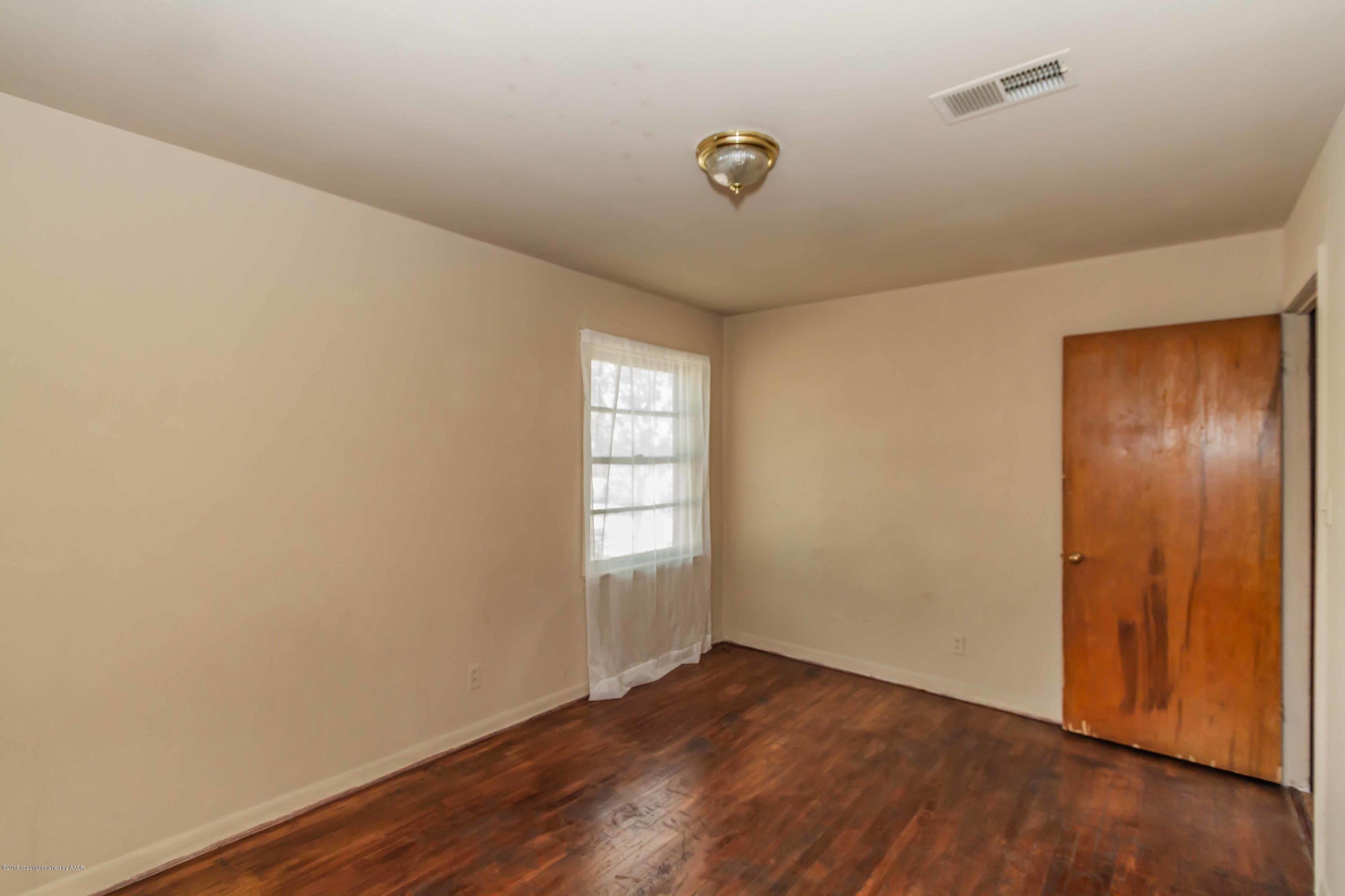 4307 Gables Street Amarillo, TX 79110 - Photo 18 of 32 an empty room with wooden floor and windows