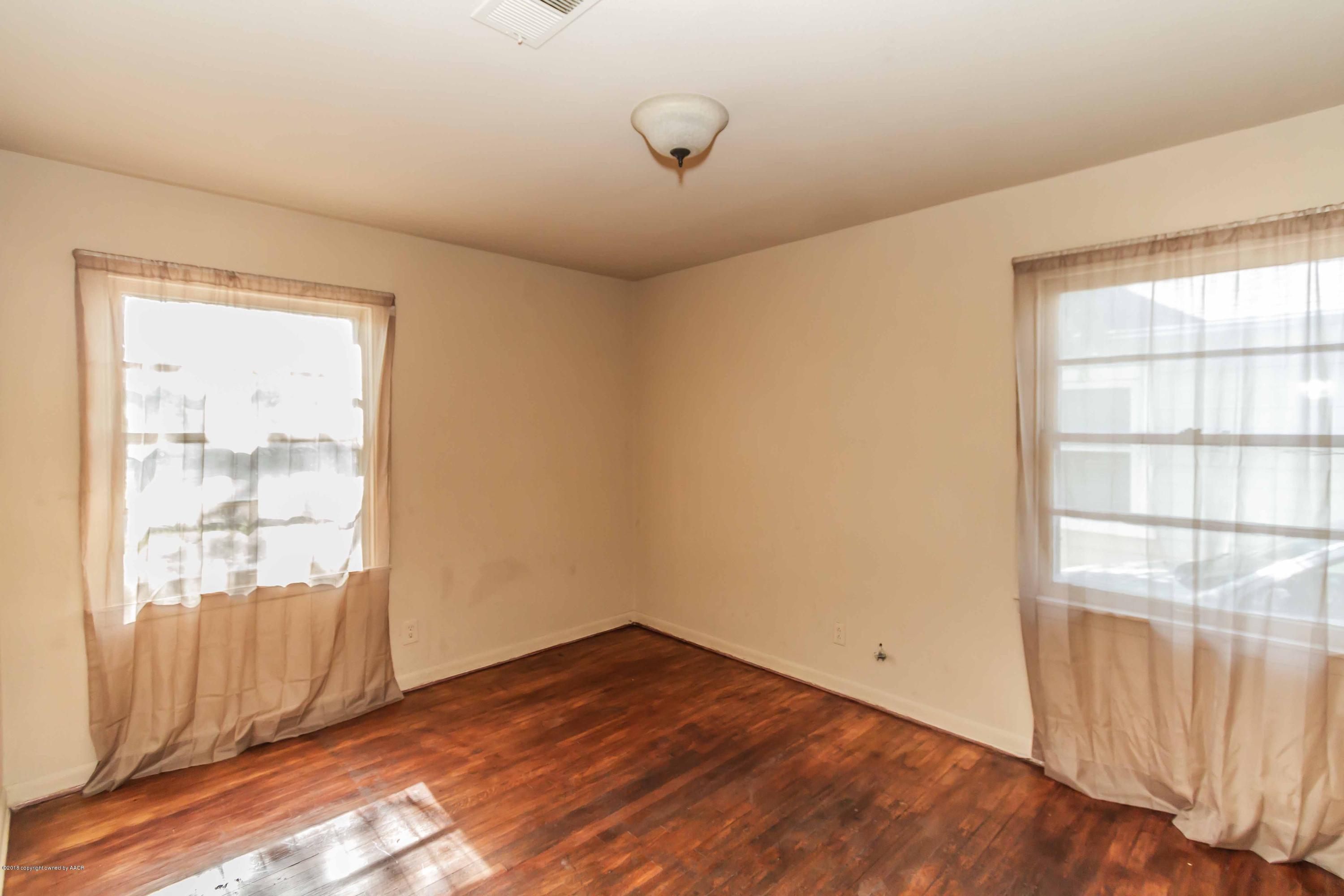 4307 Gables Street Amarillo, TX 79110 - Photo 19 of 32 an empty room with wooden floor and windows
