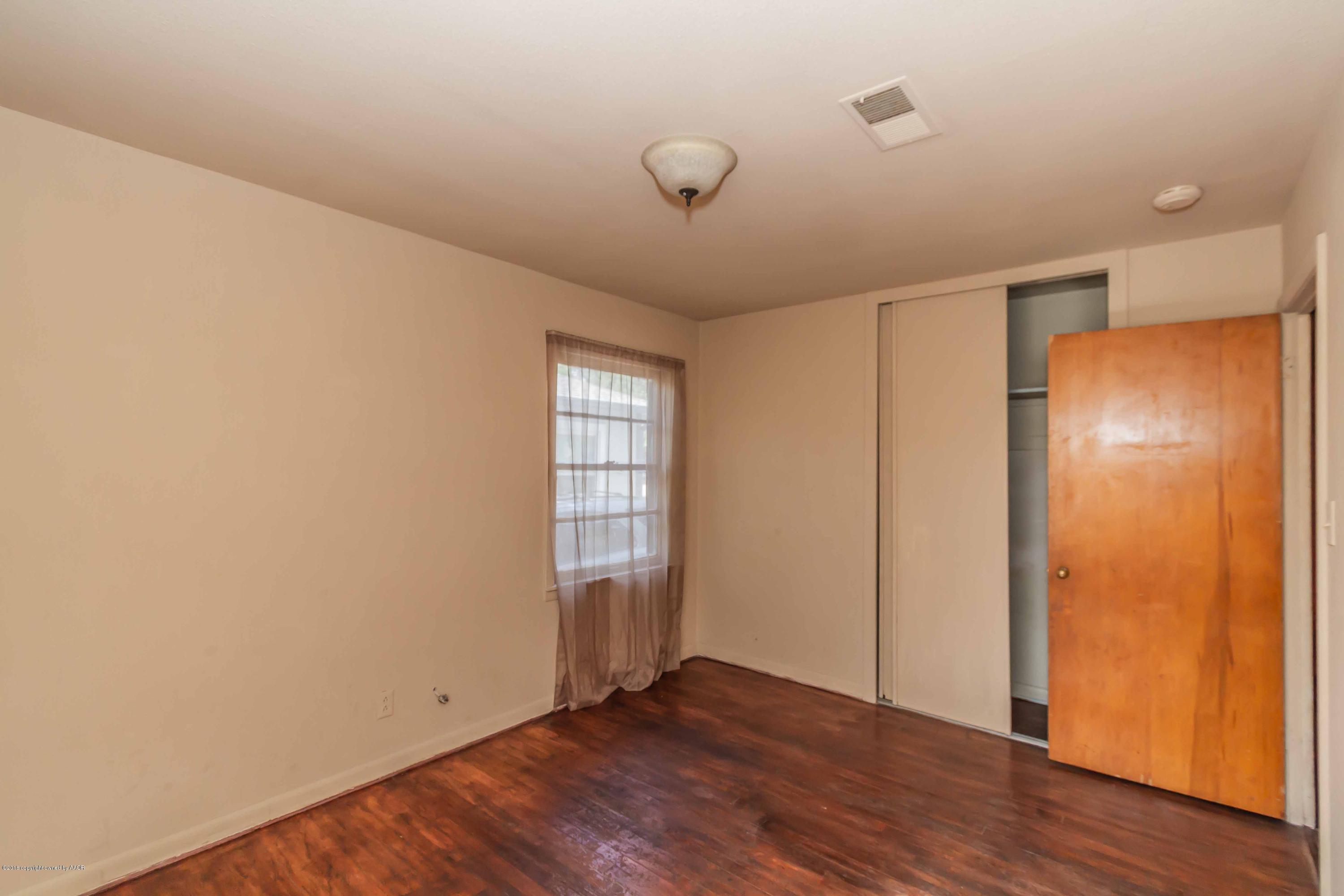 4307 Gables Street Amarillo, TX 79110 - Photo 20 of 32 a view of an empty room with wooden floor and a window