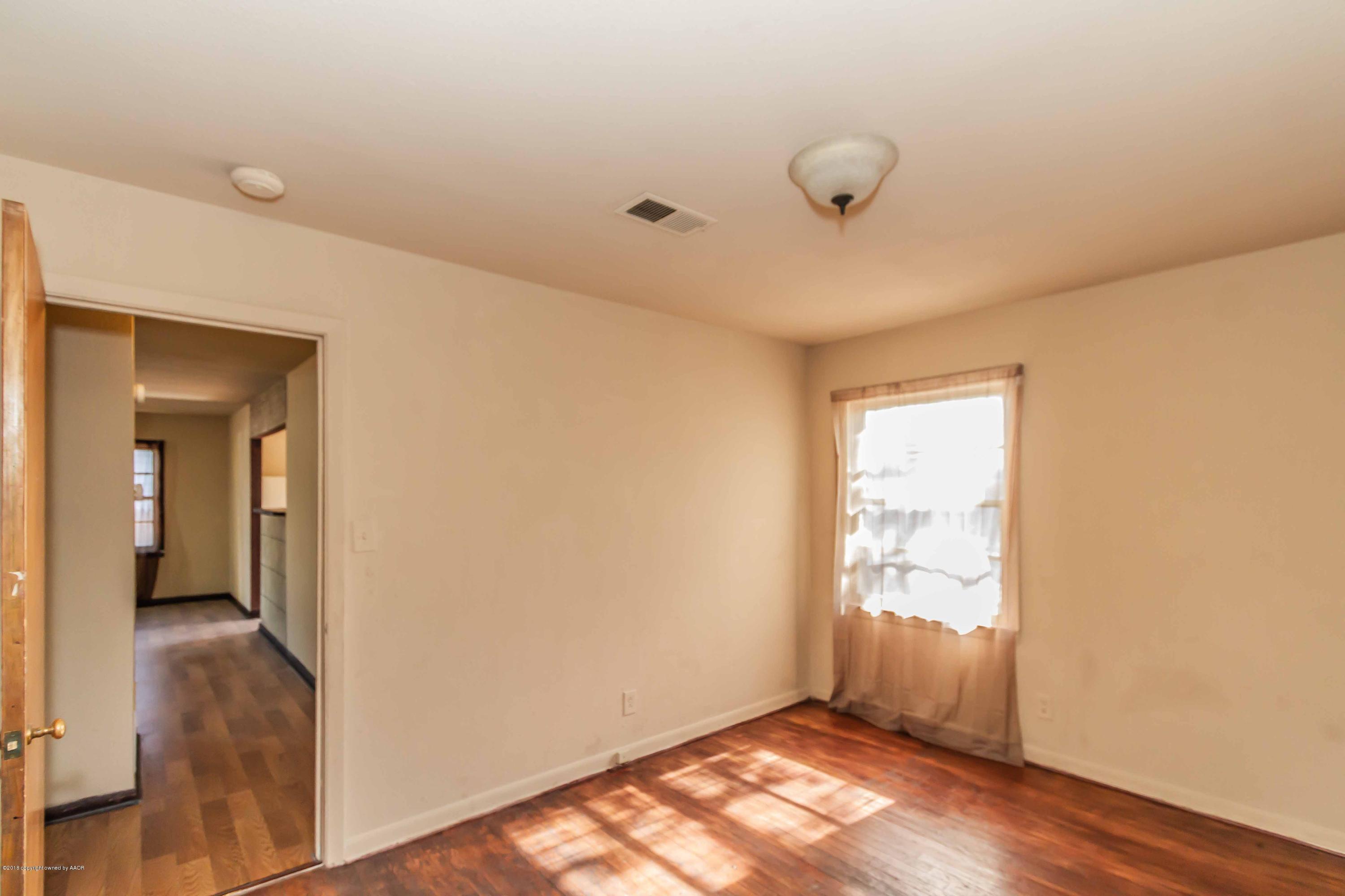 4307 Gables Street Amarillo, TX 79110 - Photo 22 of 32 an empty room with wooden floor and windows