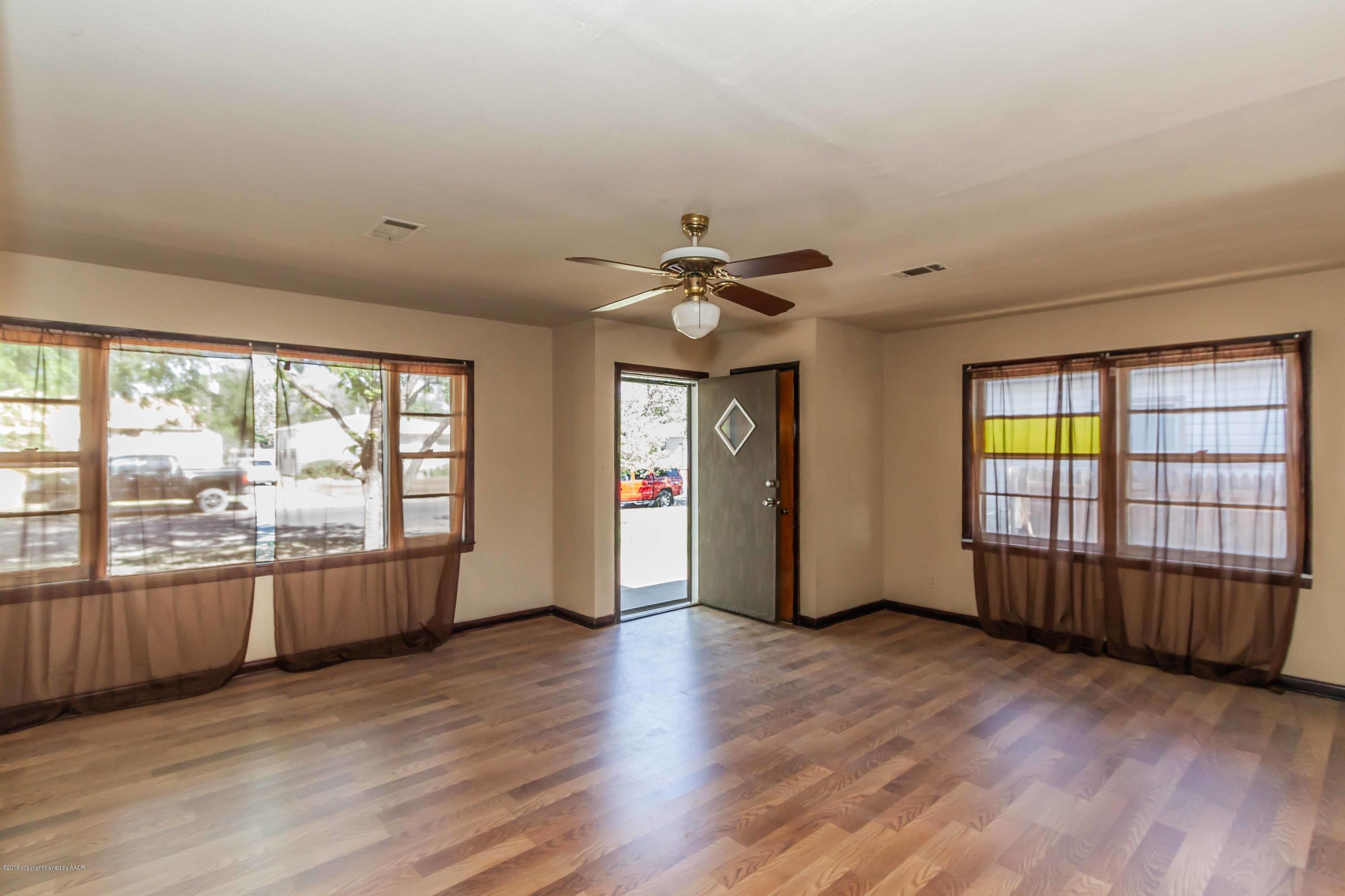 4307 Gables Street Amarillo, TX 79110 - Photo 5 of 32 an empty room with wooden floor and windows
